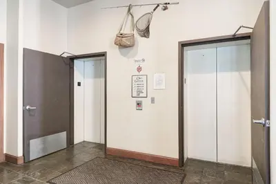 a hallway with two elevators and two doors in a building at Oro Grande 216 in Keystone