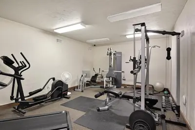 a gym with several tread machines in a room at Oro Grande 216 in Keystone