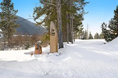 a sign in the snow next to some trees at Oro Grande 216 in Keystone