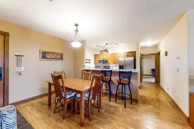 a kitchen and dining room with a wooden table and chairs at Oro Grande 216 in Keystone