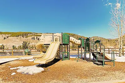 a playground with a slide at a park at Keystone Condo 8380 in Keystone