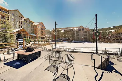 a patio with tables and chairs in a city at Keystone Condo 8380 in Keystone