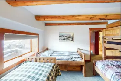 a bedroom with two beds and a window at Mountain Basecamp Hot Tub plus Pool Table in Silverthorne