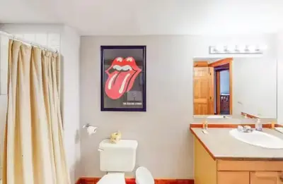 a bathroom with a picture of the mouth on the wall at Mountain Basecamp Hot Tub plus Pool Table in Silverthorne