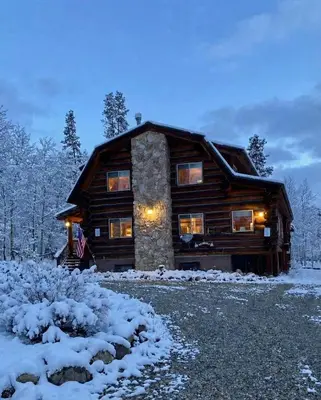 a log cabin in the snow at night at Mountain Basecamp Hot Tub plus Pool Table in Silverthorne