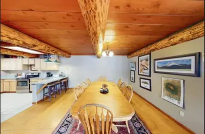 a kitchen and dining room with a wooden table and chairs at Mountain Basecamp Hot Tub plus Pool Table in Silverthorne
