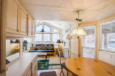 a kitchen and living room with a table and a couch at #84 Tiger Run in Breckenridge