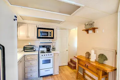 a kitchen with a stove and a microwave at #84 Tiger Run in Breckenridge