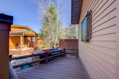 a wooden walkway next to a house with a fence at #84 Tiger Run in Breckenridge