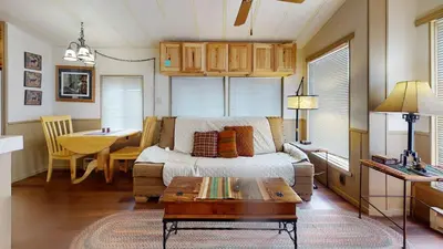 a living room with a bed and a table in it at #244 Tiger Run in Breckenridge
