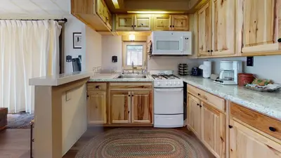 a kitchen with wooden cabinets and a white stove top oven at #244 Tiger Run in Breckenridge