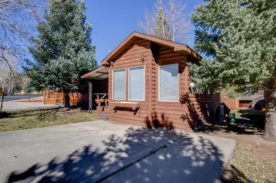 a small log cabin with a large window on a street at #244 Tiger Run in Breckenridge