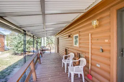 a wooden porch with white chairs on it at #244 Tiger Run in Breckenridge