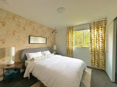 a bedroom with a white bed and a window at The Sage Sanctuary in Denver
