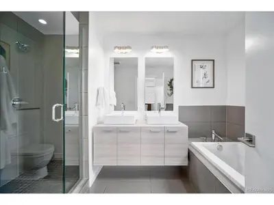 a bathroom with two sinks and a tub and a toilet at The Sage Sanctuary in Denver