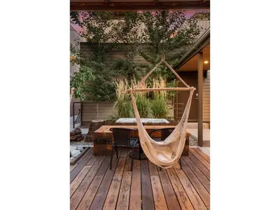 a hammock on a deck with a table at The Sage Sanctuary in Denver