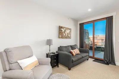 a living room with a couch and a chair at Stylish Grand Lake Retreat - King Bed - Walk to Lake in Grand Lake