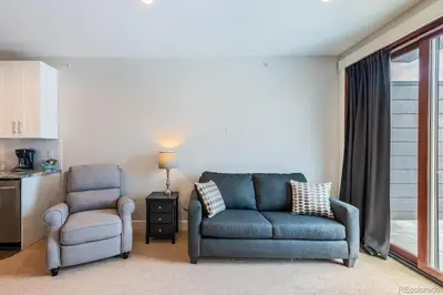 a living room with a couch and a chair at Stylish Grand Lake Retreat - King Bed - Walk to Lake in Grand Lake