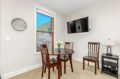 a dining room with a table and chairs and a window at Stylish Grand Lake Retreat - King Bed - Walk to Lake in Grand Lake
