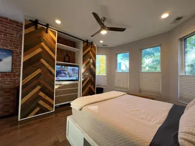 a bedroom with a bed and a wall of windows at UPTOWN CASTLE - CITY VIEWS - THEATER & CONVENTION DISTRICT! in Denver