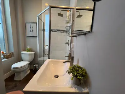 a bathroom with a sink and a toilet and a shower at UPTOWN CASTLE - CITY VIEWS - THEATER & CONVENTION DISTRICT! in Denver