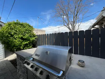 a grill on a table in front of a fence at UPTOWN CASTLE - CITY VIEWS - THEATER & CONVENTION DISTRICT! in Denver