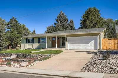 a house with a garage and a driveway at Bright and Cozy Ranch Style House Centennial in Centennial