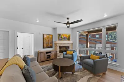 a living room with a couch and chairs and a fireplace at Brightwood 309 in Keystone