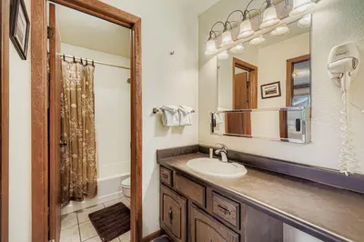 a bathroom with a sink and a mirror at Snowdance C304 condo in Keystone