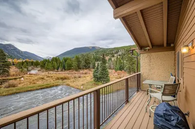 a balcony with a table and chairs and a view at Snowdance C304 condo in Keystone