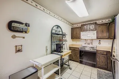 a kitchen with wooden cabinets and a white counter top at Snowdance C304 condo in Keystone