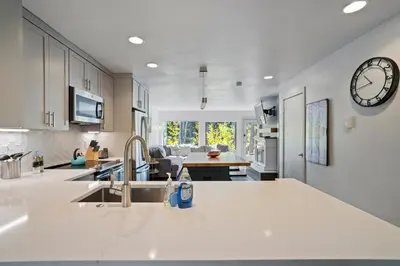 a kitchen with a sink and a clock on the wall at 1928 Soda Ridge in Keystone