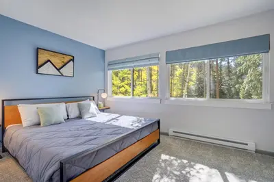 a bedroom with a bed and two windows at 1928 Soda Ridge in Keystone