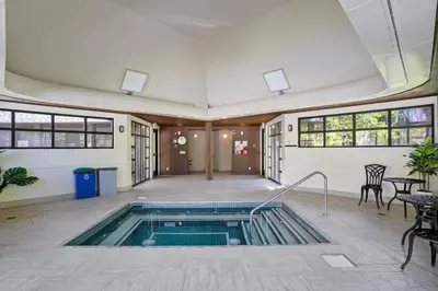 a swimming pool in a room with a table and chairs at 1928 Soda Ridge in Keystone