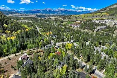 an aerial view of a town with trees and mountains at 1928 Soda Ridge in Keystone