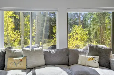 a living room with a couch in front of a window at 1928 Soda Ridge in Keystone