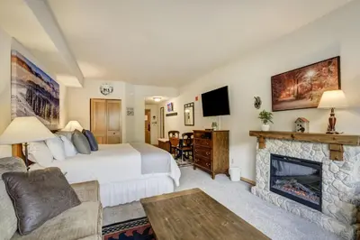 a bedroom with a bed and a fireplace at #5072 Keystone in Keystone