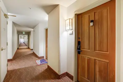 a hallway with a wooden door in a building at #5072 Keystone in Keystone