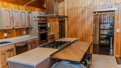 a kitchen with wooden cabinets and a stove top oven at Grand Lodge in Estes Park