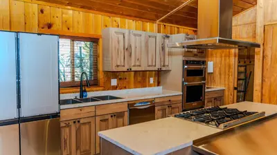 a kitchen with wooden cabinets and a stove top oven at Grand Lodge in Estes Park