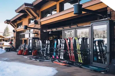 a bunch of skis are lined up outside of a building at Kindred Resort Luxury Ski In, Ski Out 1 Bedroom Residence At The River Run Gondola in Dillon