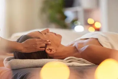 a woman laying on a towel on a bed at Kindred Resort Luxury Ski In, Ski Out 1 Bedroom Residence At The River Run Gondola in Dillon