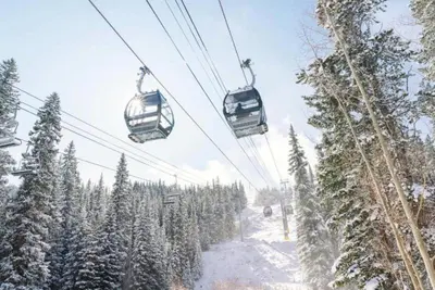 two gondolas on a ski lift in the snow at Kindred Resort Luxury Ski In, Ski Out 1 Bedroom Residence At The River Run Gondola in Dillon