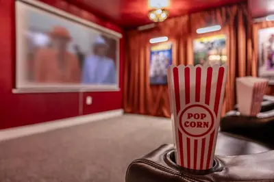 a cup ofpop corn sitting on a table in a room at Movie Theater and Mini Golf with 2 King Beds in Westminster