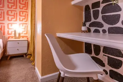 a room with a desk and a white chair at Movie Theater and Mini Golf with 2 King Beds in Westminster