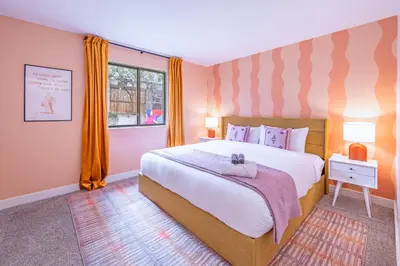 a bedroom with a large bed and a window at Movie Theater and Mini Golf with 2 King Beds in Westminster