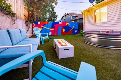 a backyard with a pool table and blue chairs and a pool table at Movie Theater and Mini Golf with 2 King Beds in Westminster