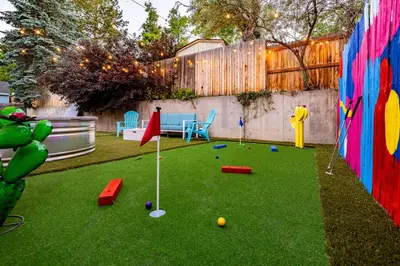 a miniature golf course in a backyard with a fence at Movie Theater and Mini Golf with 2 King Beds in Westminster