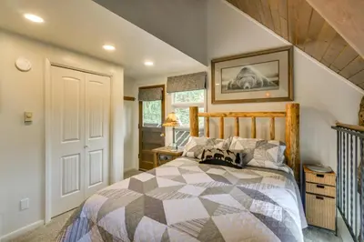 a bedroom with a bed with a wooden headboard at The Mountain Chalet - Free Ski Shuttle to Lifts! in Winter Park