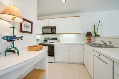 a kitchen with white cabinets and a sink at Mtn-View Deck, Workspace! Walkable Frisco Condo in Frisco